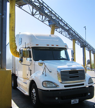 Photo of a tractor trailer hooked up to a truck stop electrification unit.