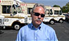 Photo of a man in front of delivery vans 