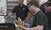 Photo of an adult and two students wearing safety glasses in a laboratory